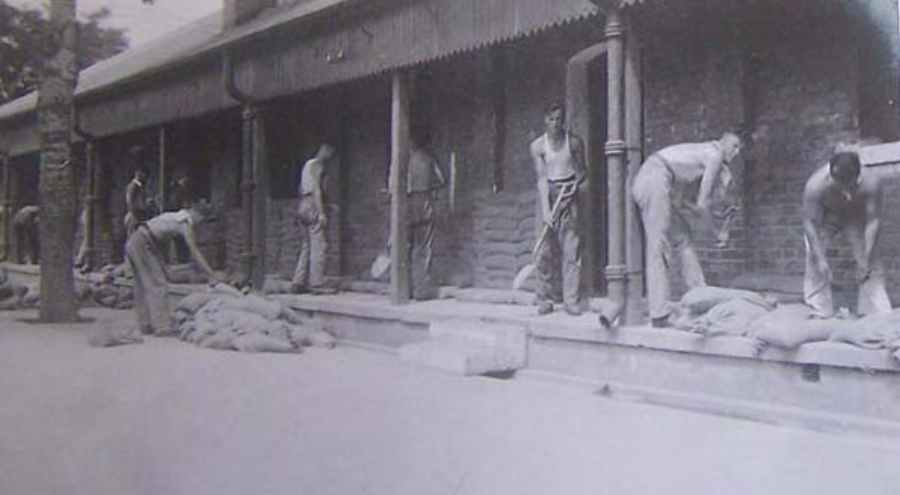 Sandbagging barracks against attack